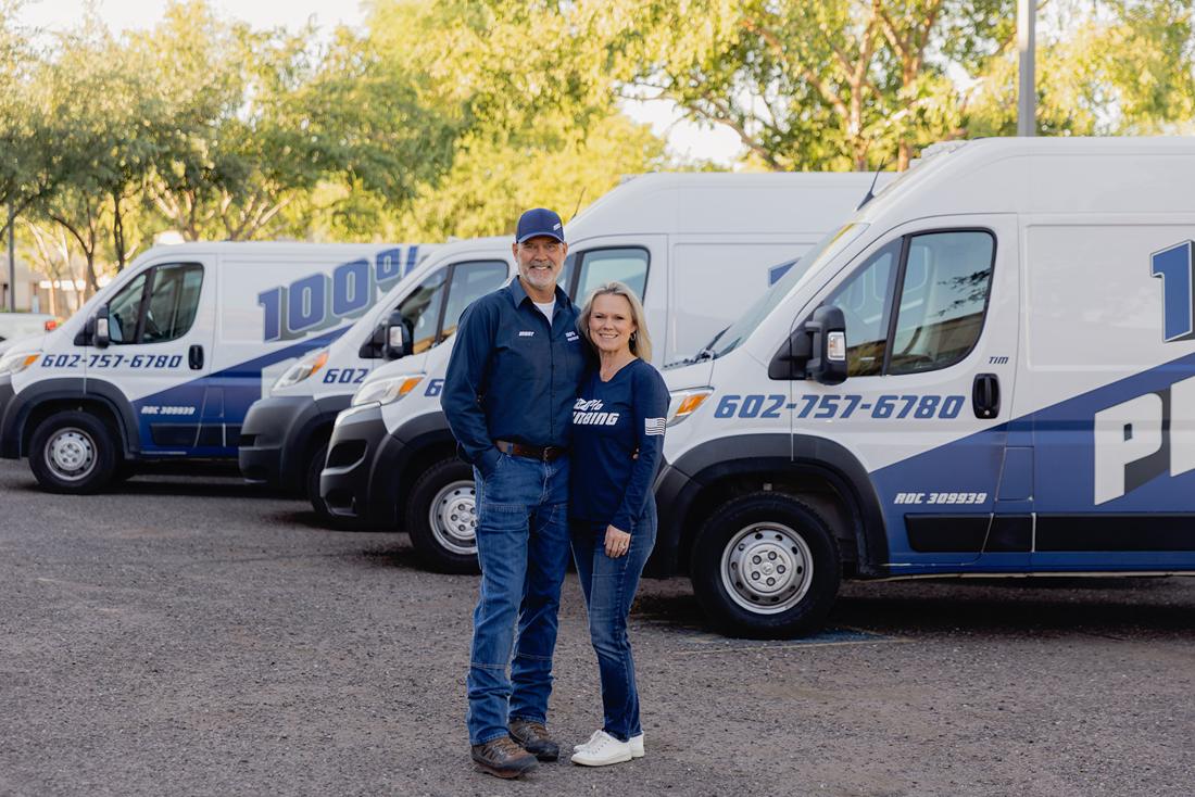 Mont Stephenson, owner of 100% Plumbing, with his wife in front of the fleet